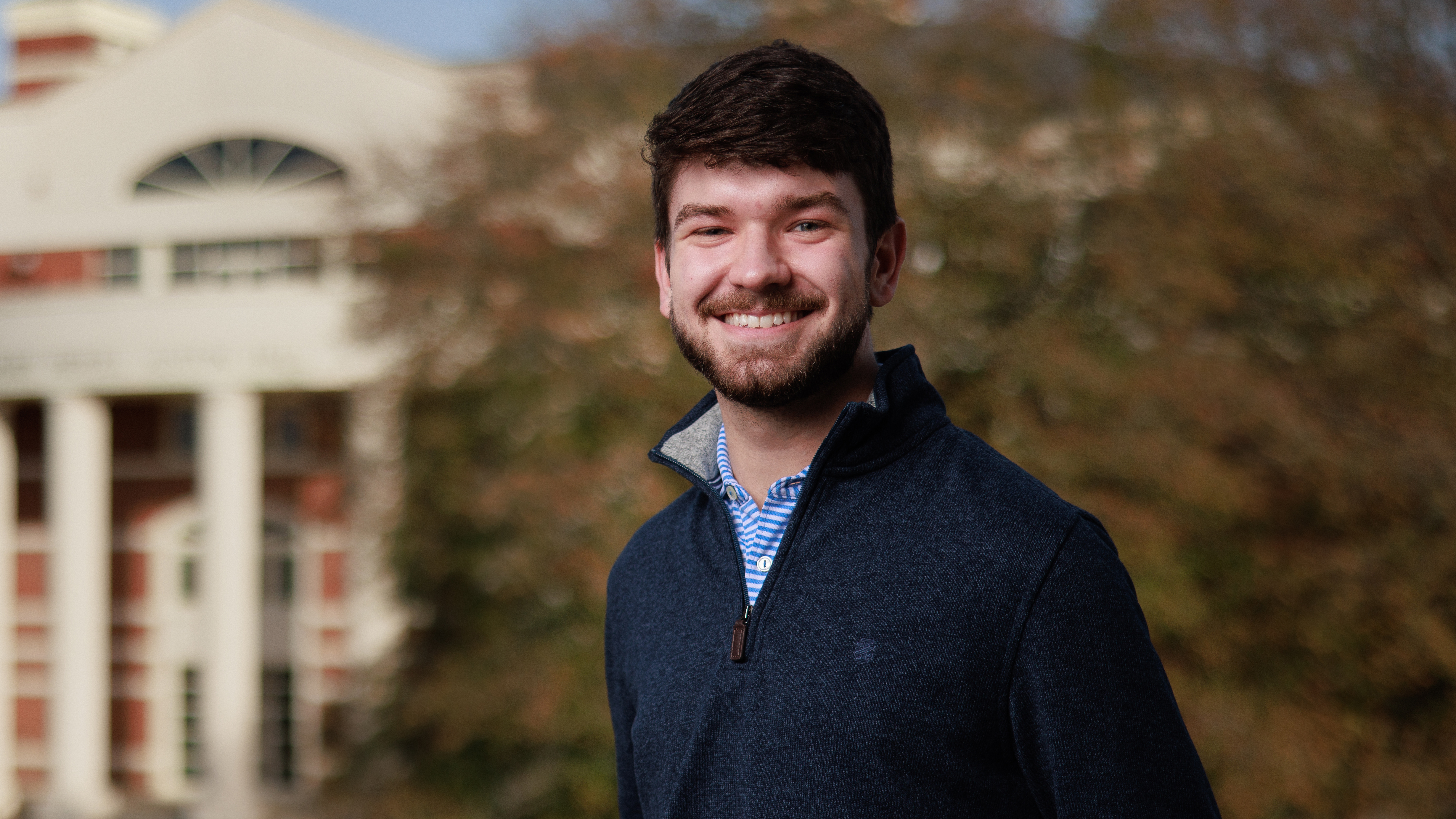 Connor Higgins in front of a building.