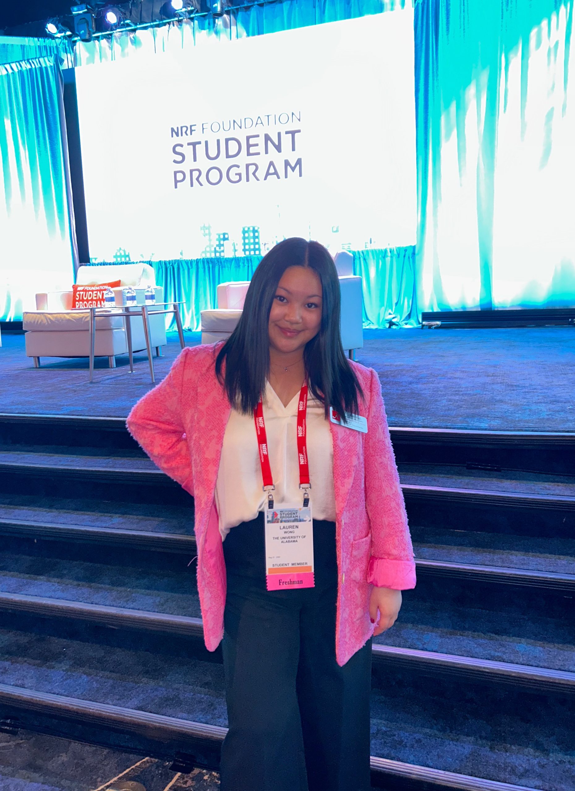Student in pink jacket at a conference