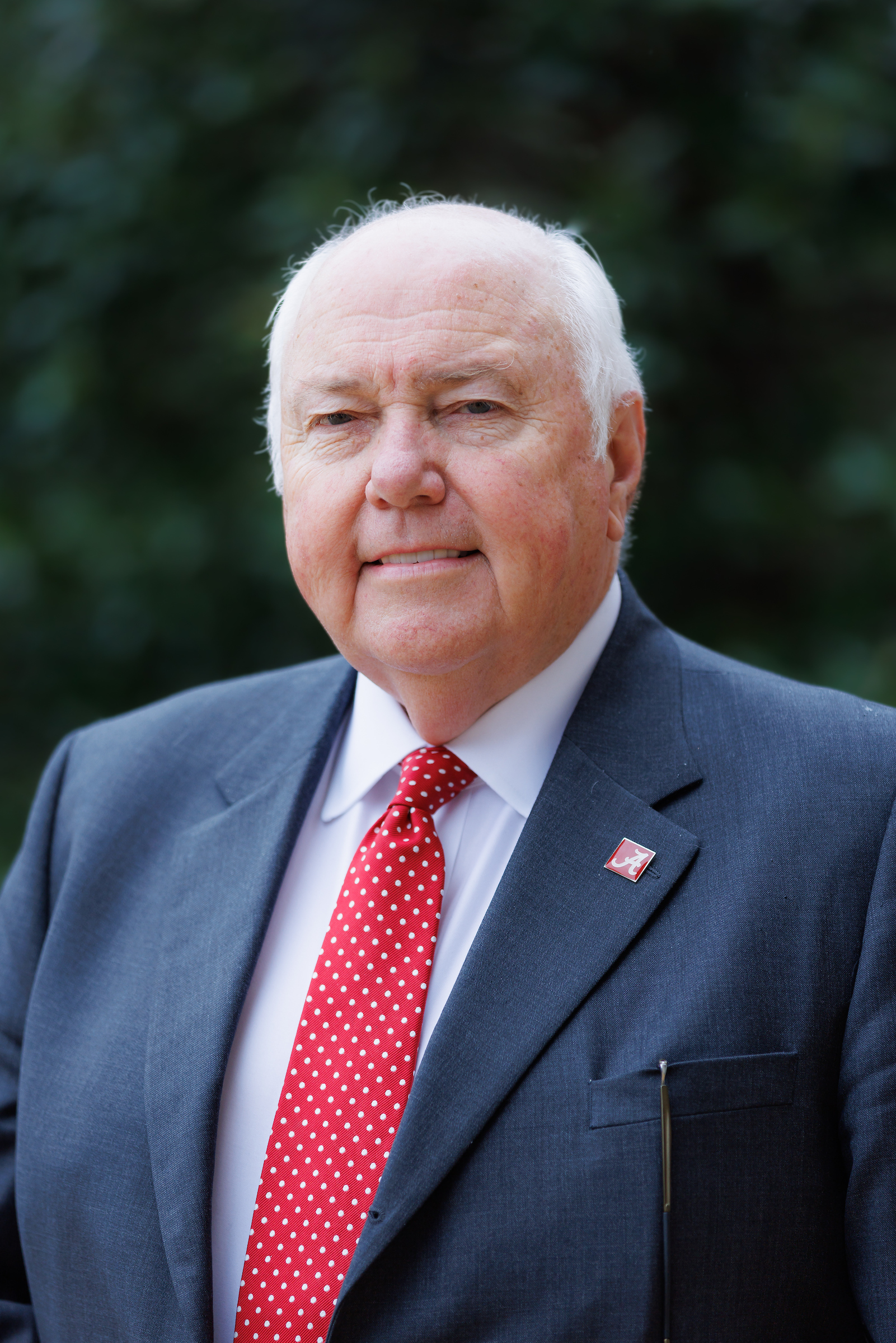 A white man poses for a portrait outdoors