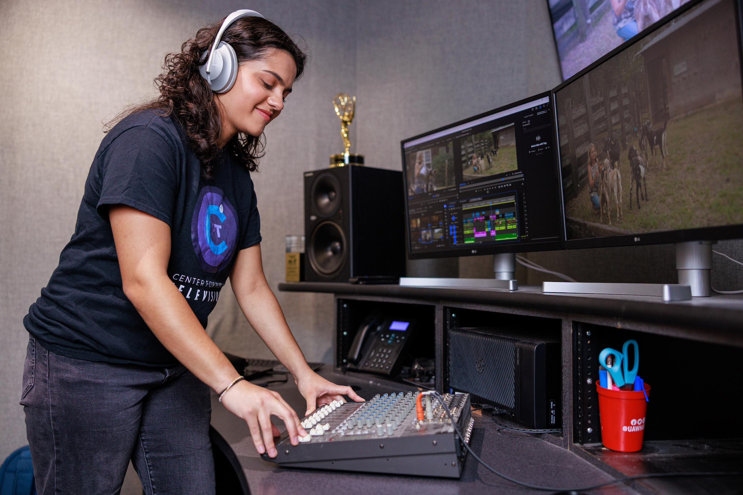 A female college student edits a video on a computer